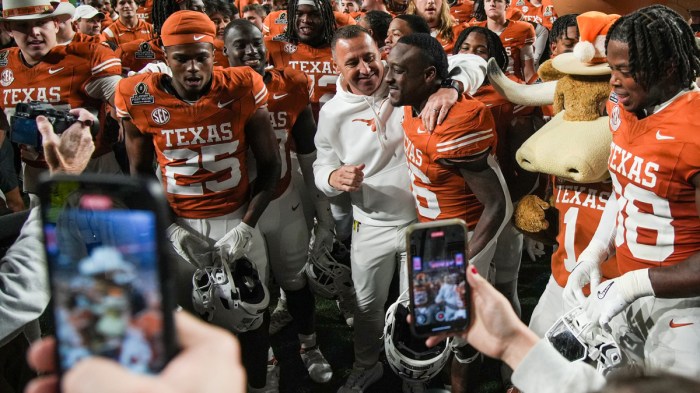 Texas Longhorns head coach Steve Sarkisian and Texas Longhorns running back Quintrevion Wisner (26) celebrate a win over Clemson Tigers 38-24 in the NCAA College Football Playoffs first round game at Darrell K Royal Texas Memorial Stadium, Austin, Texas, Saturday, Dec. 21, 2024.