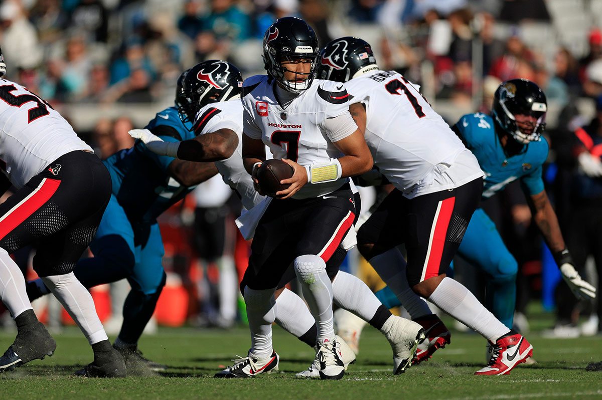 Houston Texans quarterback C.J. Stroud (7) fakes a hand-off during the third quarter of an NFL football matchup Sunday, Dec. 1, 2024 at EverBank Stadium in Jacksonville, Fla. The Texans held off the Jaguars 23-20.