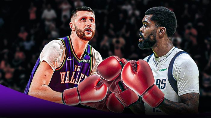 Jusuf Nurkic and Naji Marshall with red punching gloves over their hands in the Suns arena.