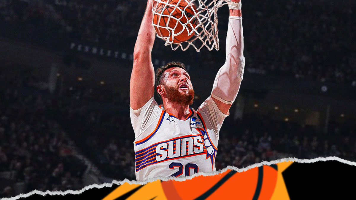 Suns Jusuf Nurkic dunking a basketball.