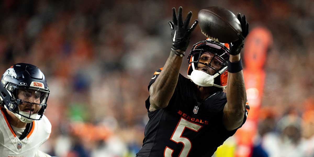 Cincinnati Bengals wide receiver Ty Higgins (5) catches a pass inside the 5-yard line as Denver Broncos cornerback Riley Moss (21) defends in overtime of an NFL game at Paycor Stadium in Cincinnati, Saturday, Dec. 28, 2024.