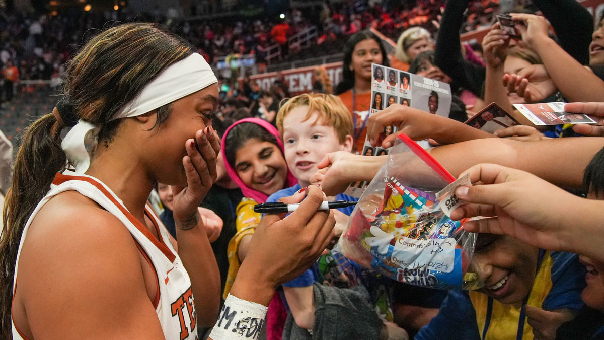 Texas Longhorns forward Aaliyah Moore (23) signs fans posters and cards after the game against the Tarleton State.