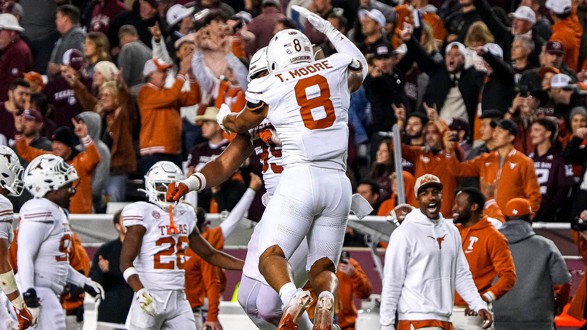 Texas Longhorns edge rusher Trey Moore (8)and defensive lineman Alfred Collins (95) celebrate a defensive stop during the Lone Star Showdown against the Texas A&M Aggies at Kyle Field on Saturday, Nov. 30, 2024 in College Station, Texas.