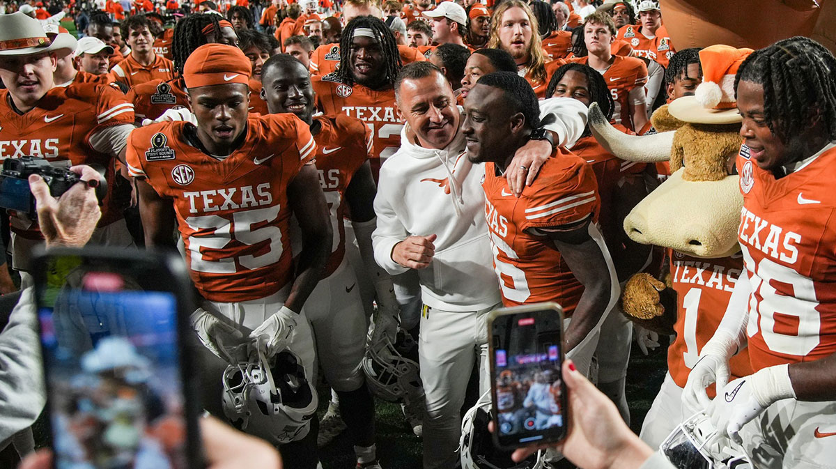 Texas Longhorns head coach Steve Sarkisian and Texas Longhorns running back Quintrevion Wisner (26) celebrate a win over Clemson Tigers 38-24 in the NCAA College Football Playoffs first round game at Darrell K Royal Texas Memorial Stadium