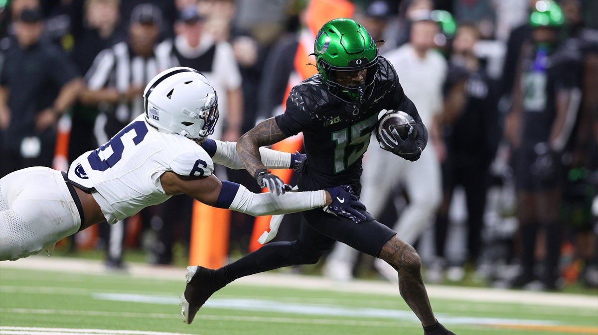 Dec 7, 2024; Indianapolis, IN, USA; Oregon Ducks wide receiver Tez Johnson (15) avoids the tackle by Penn State Nittany Lions safety Zakee Wheatley (6) during the fourth quarter in the 2024 Big Ten Championship game at Lucas Oil Stadium. Mandatory Credit: Jordan Prather-Imagn Images