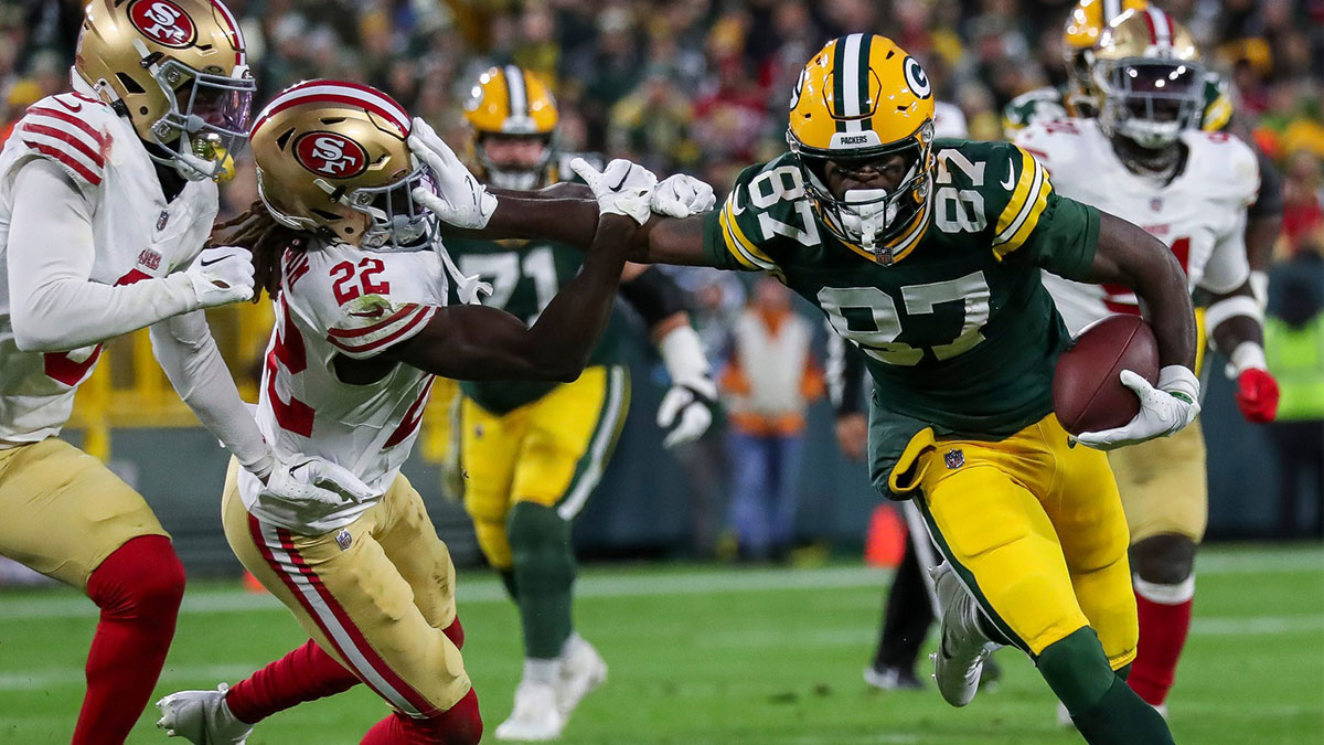 Green Bay Packers wide receiver Romeo Doubs (87) stiff-arms San Francisco 49ers cornerback Isaac Yiadom (22) as he runs after making a catch on Sunday, November 24, 2024, at Lambeau Field in Green Bay, Wis. The Packers won the game, 38-10.