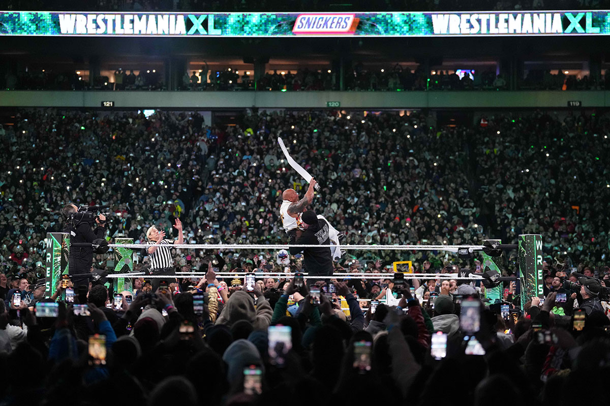 The Undertaker Chokeslamming The Rock at WrestleMania XL during the main event between Cody Rhodes and Roman Reigns.