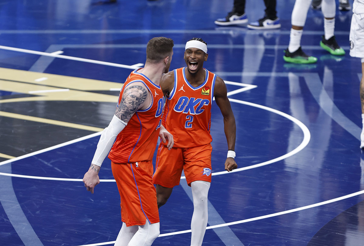 Thunder guard Shai Gilgeous-Alexander (2) celebrates with center Isaiah Hartenstein (55) after he dunks against the Dallas Mavericks during the third quarter at Paycom Center