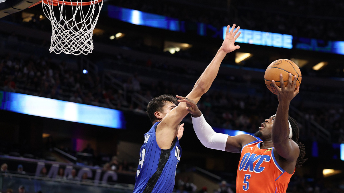 Thunder guard Luguentz Dort (5) drives to the hoop guarded by Orlando Magic forward Tristan da Silva (23) in the fourth quarter at Kia Center