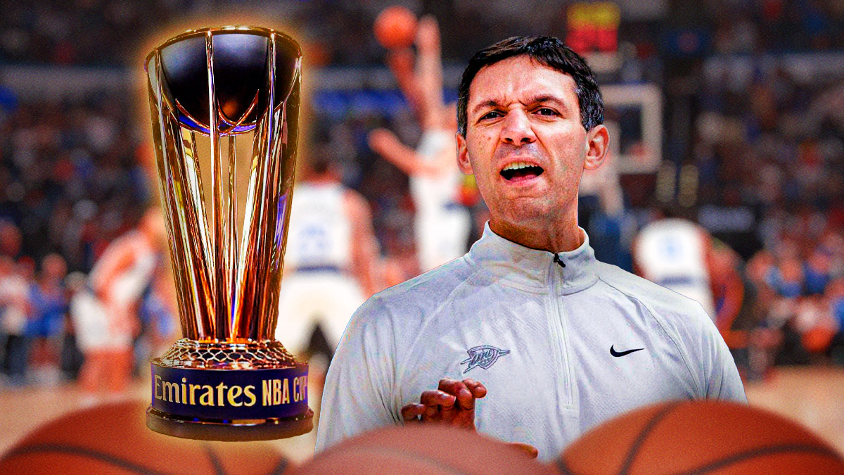 Mark Daigneault next to a NBA Cup.