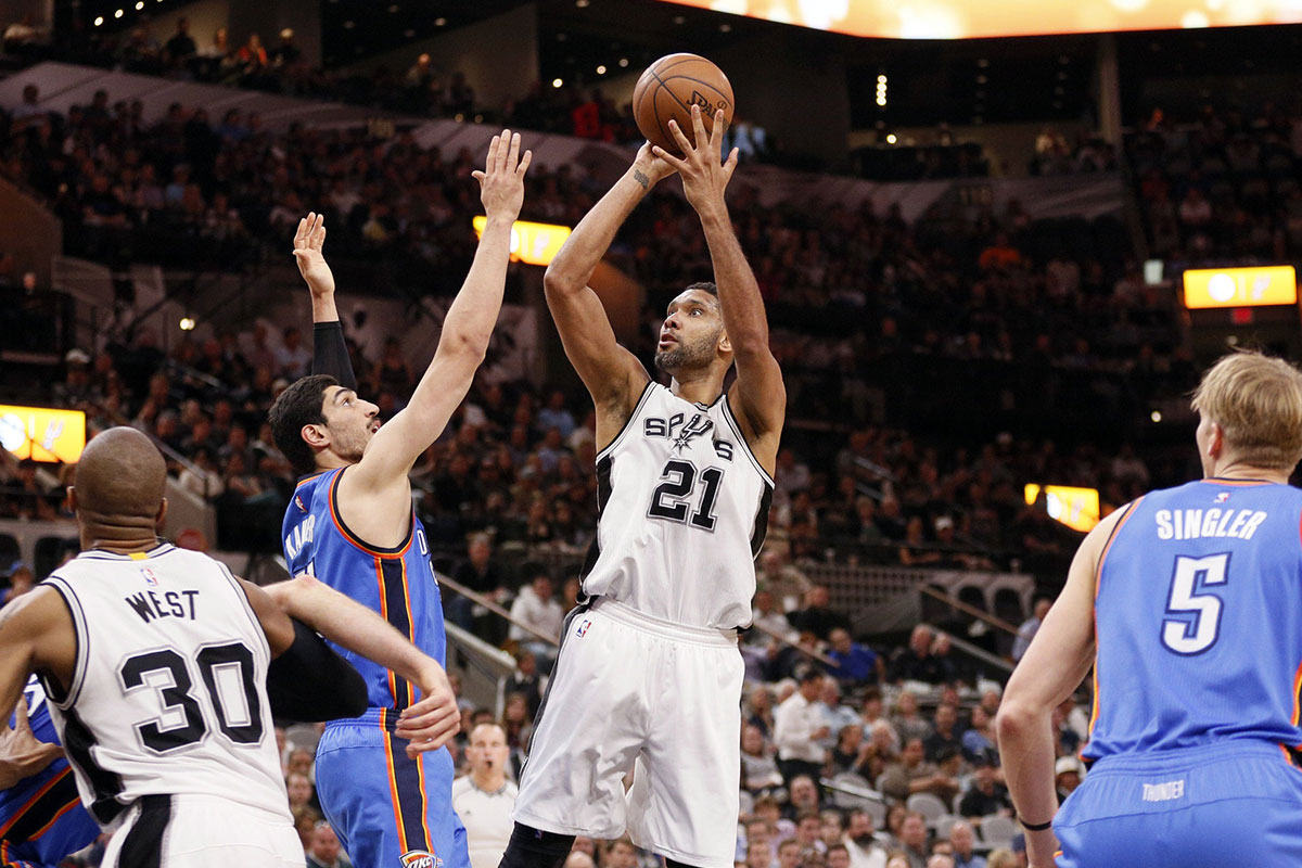 San Antonio Spurs power forward Tim Duncan (21) shoots the ball over Oklahoma City Thunder center Enes Kanter (11, left) during the first half at AT&T Center. 