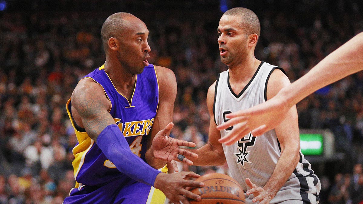Los Angeles Lakers small forward Kobe Bryant (24) passes the ball around San Antonio Spurs point guard Tony Parker (9) during the first half at AT&T Center.