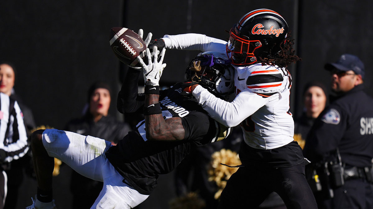 Colorado Buffaloes wide receiver Travis Hunter (12) pulls in at touchdown reception as Oklahoma State Cowboys cornerback Kale Smith (10) in the fourth quarter at Folsom Field.