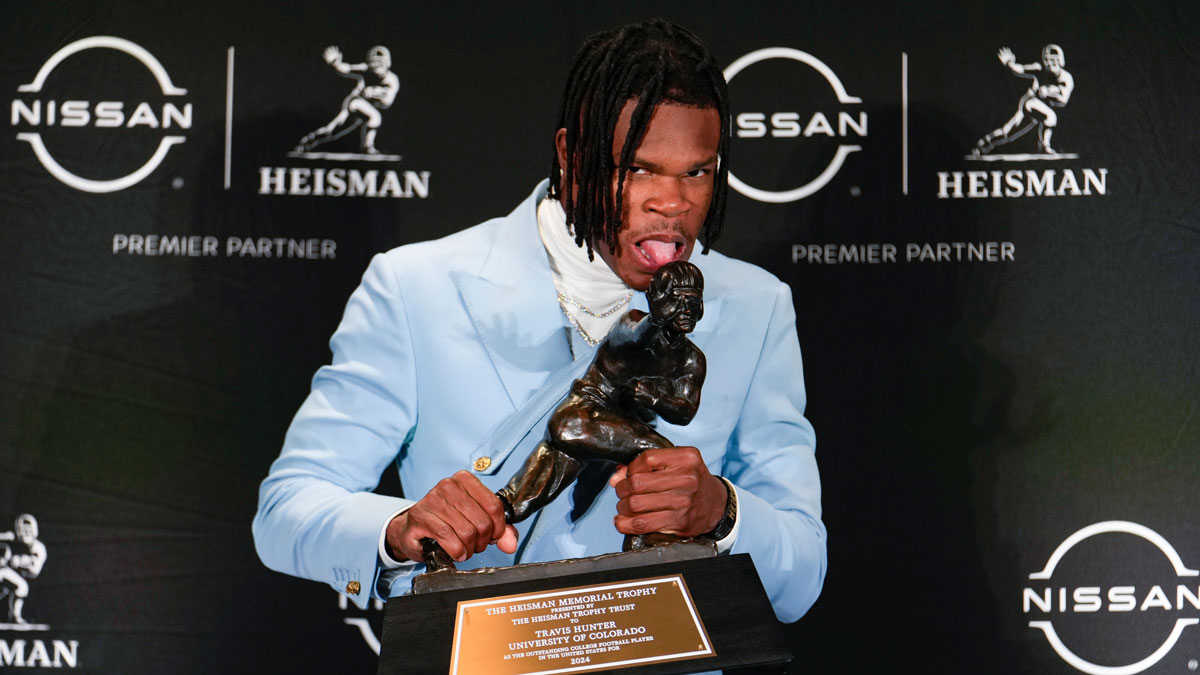 Colorado Buffalos football star Travis Hunter, who deactivated his social media account as well as his fiancée Leanna Lenee, with the Heisman Trophy.