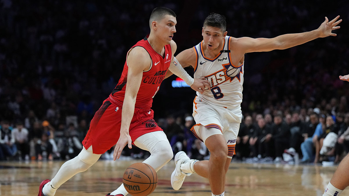 Miami Heat guard Tyler Herro (14) drives against Phoenix Suns guard Grayson Allen (8) during the second half at Kaseya Center.
