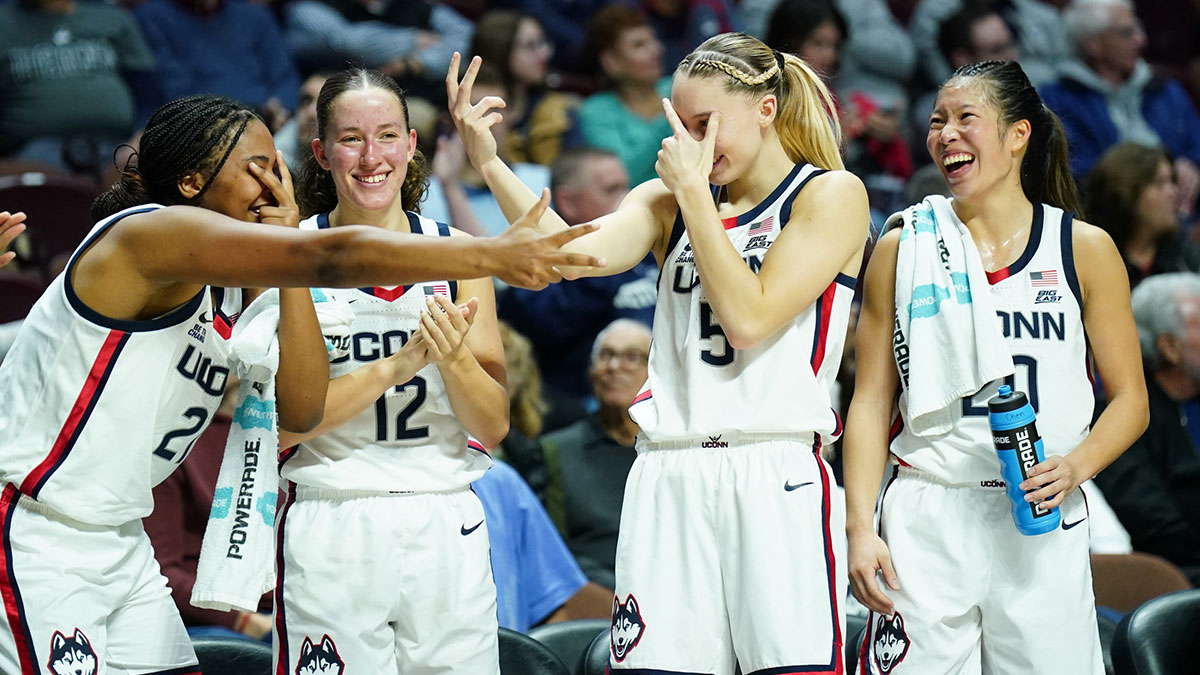 UConn Huskies forward Sarah Strong (21), guard Ashlynn Shade (12), guard Paige Bueckers (5) and guard Kaitlyn Chen (20) react after a three point basket against the Iowa State Cyclones in the first half at Mohegan Sun Arena.
