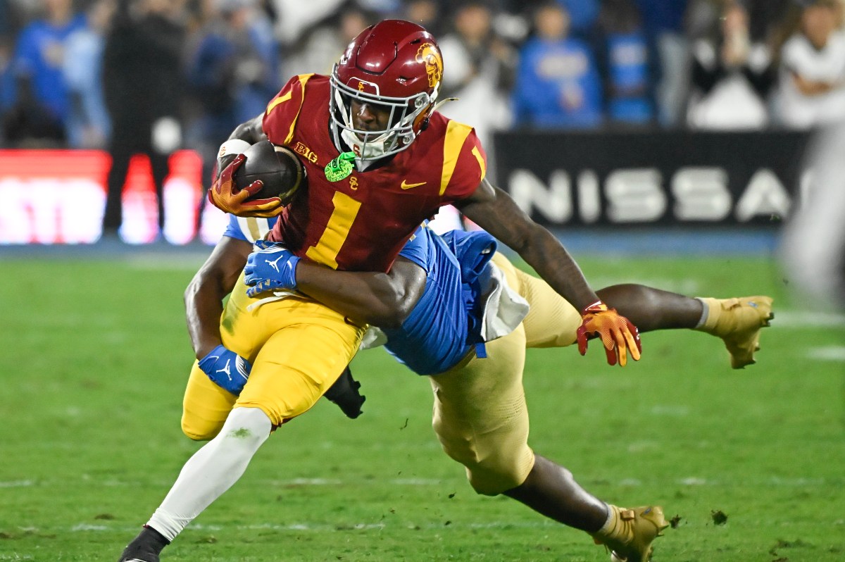 USC Trojans wide receiver Zachariah Branch (1) is tackled by UCLA Bruins linebacker Jalen Woods (17) during the second quarter at Rose Bowl.