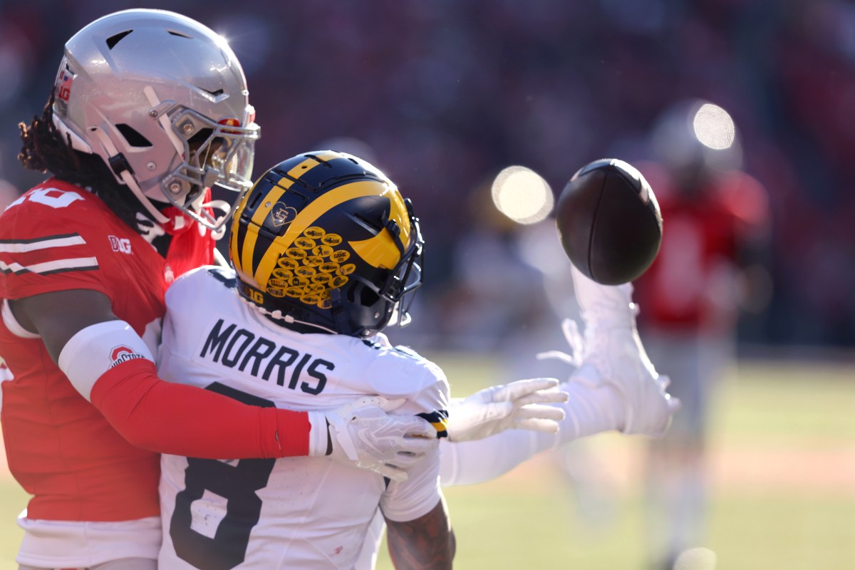 Michigan Wolverines wide receiver Tyler Morris (8) attempts to catch the football as Ohio State Buckeyes cornerback Denzel Burke (10) interferes on the play during the fourth quarter at Ohio Stadium.