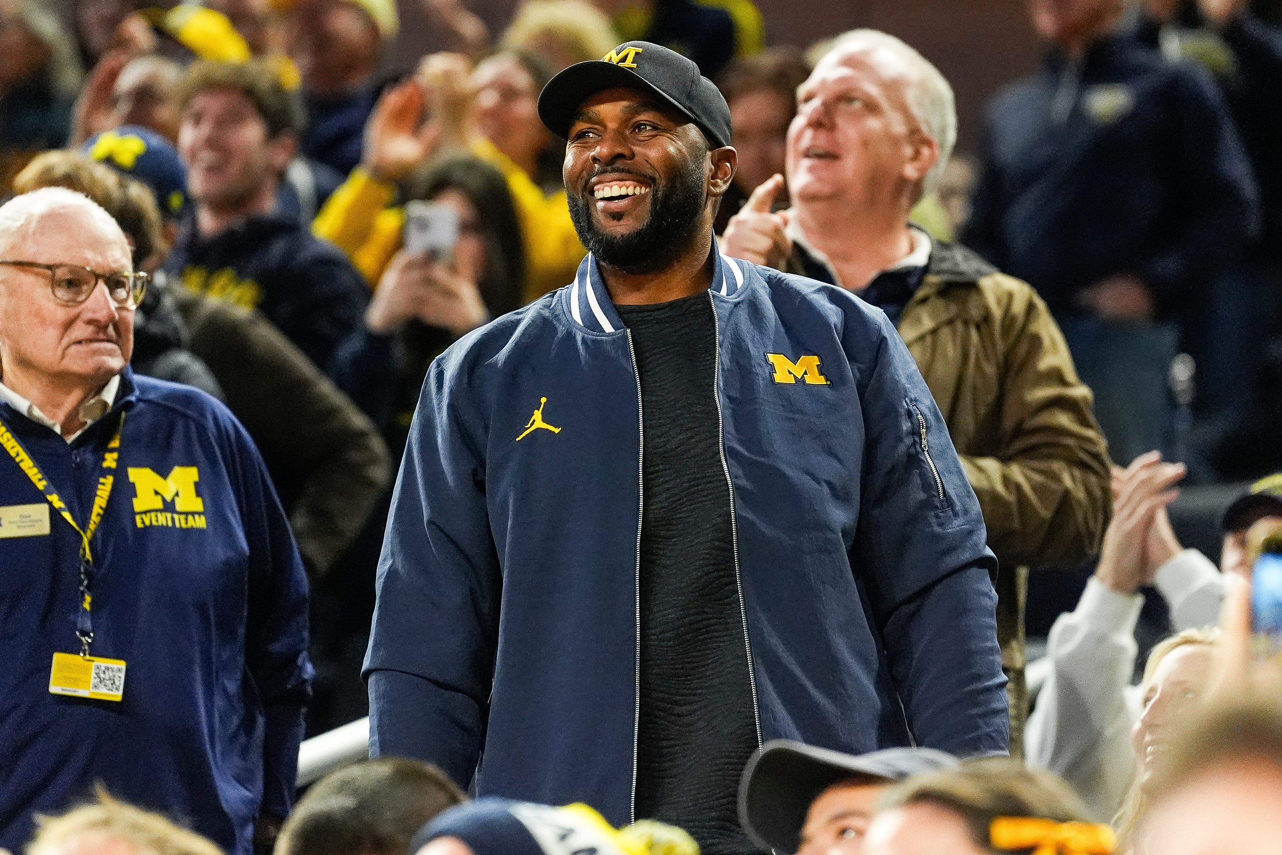 Michigan football head coach Sherron Moore smiles at fans during the first half against Iowa at Crisler Center