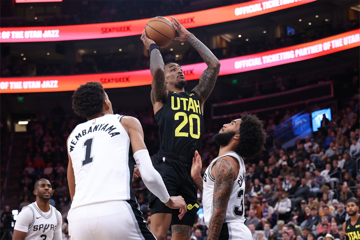 Utah Jazz Forward John Collins (20) Drives Between San Antonio Spurs Center Victor Vembaniama (1) and Next Julian Champagnie (30) During the fourth district in Delta Centur