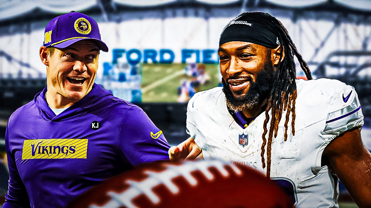 Vikings HC Kevin O Connell smiling/happy looking at RB Aaron Jones. Background is Ford Field.