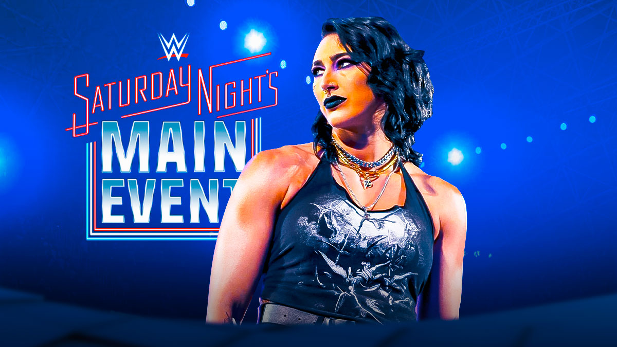 Rhea Ripley in front of the Saturday Night's Main Event logo