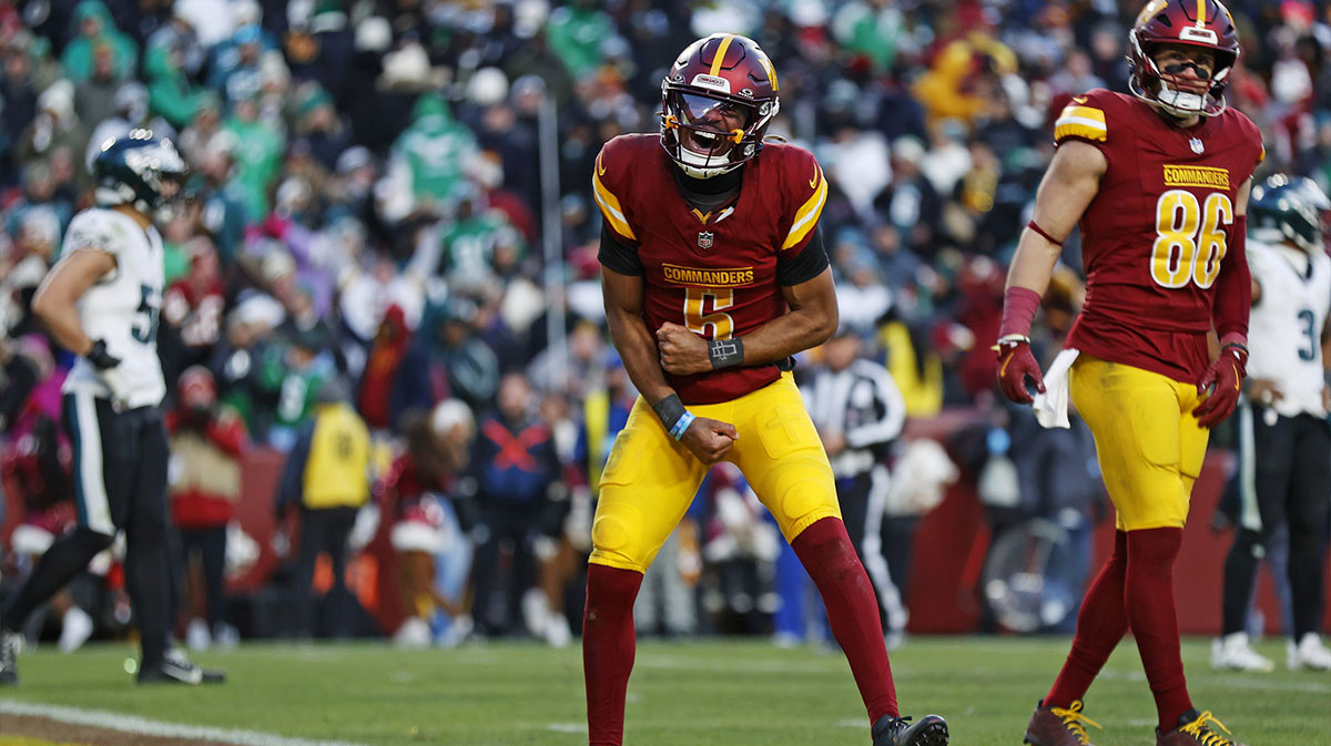 Washington Commanders quarterback Jayden Daniels (5) celebrates after throwing the game winning touchdown during the fourth quarter against the Philadelphia Eagles at Northwest Stadium.