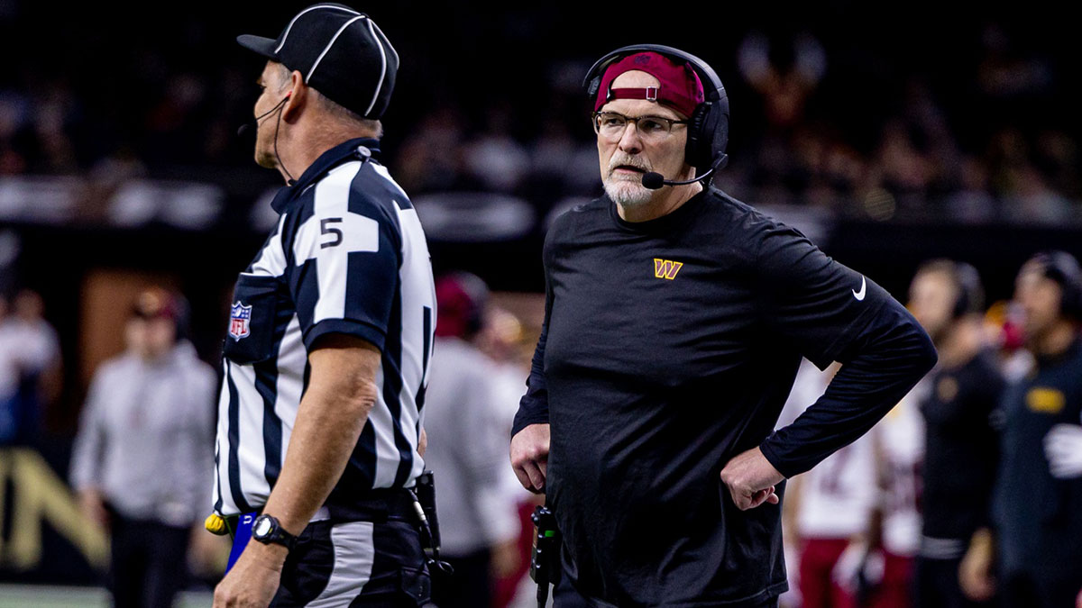 Washington Commanders head coach Dan Quinn talks to side judge Jim Quirk (5) against the New Orleans Saints during the first half at Caesars Superdome.