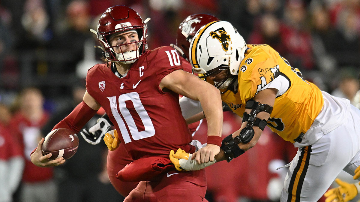 Washington State Cougars quarterback John Mateer (10) is sacked by Wyoming Cowboys defensive end DeVonne Harris (93) in the second half at Gesa Field at Martin Stadium. Washington State Cougars won 15-14.