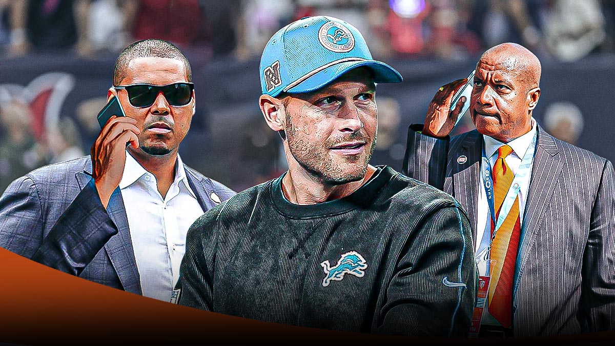 Chicago Bears general manager Ryan Poles talking and/or on phone on left side, Chicago Bears team president Kevin Warren on right side, Detroit Lions offensive coordinator Ben Johnson calling plays/coaching in center, Soldier Field (home field of the Chicago Bears) in background