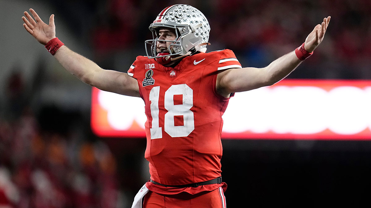 Ohio State Buckeyes quarterback Will Howard (18) celebrates a touchdown by running back TreVeyon Henderson during the second half of the College Football Playoff first round game against the Tennessee Volunteers.