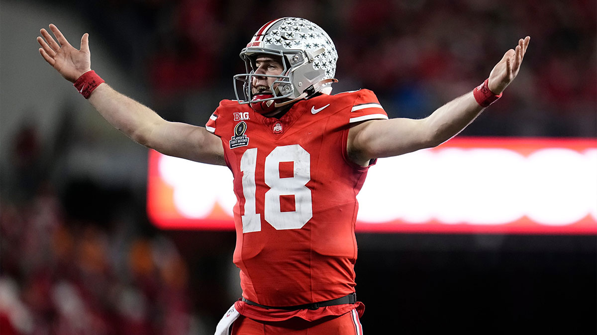 Ohio State Buckeyes quarterback Will Howard (18) celebrates a touchdown by running back TreVeyon Henderson during the second half of the College Football Playoff first round game against the Tennessee Volunteers at Ohio Stadium in Columbus on Dec. 22, 2024. Ohio State won 42-17.