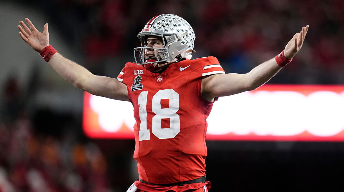 Ohio State Buckeyes quarterback Will Howard (18) celebrates a touchdown by running back TreVeyon Henderson during the second half of the College Football Playoff first round game against the Tennessee Volunteers at Ohio Stadium