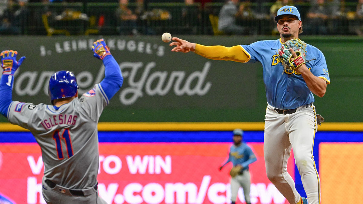 Milwaukee Brewers shortstop Willy Adames (27) completes a double play after forcing out New York Mets second baseman Jose Iglesias (11) in the fifth inning at American Family Field. 