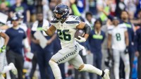 Dec 8, 2024; Glendale, Arizona, USA; Seattle Seahawks running back Zach Charbonnet (26) runs for a touchdown against the Arizona Cardinals in the first half at State Farm Stadium.