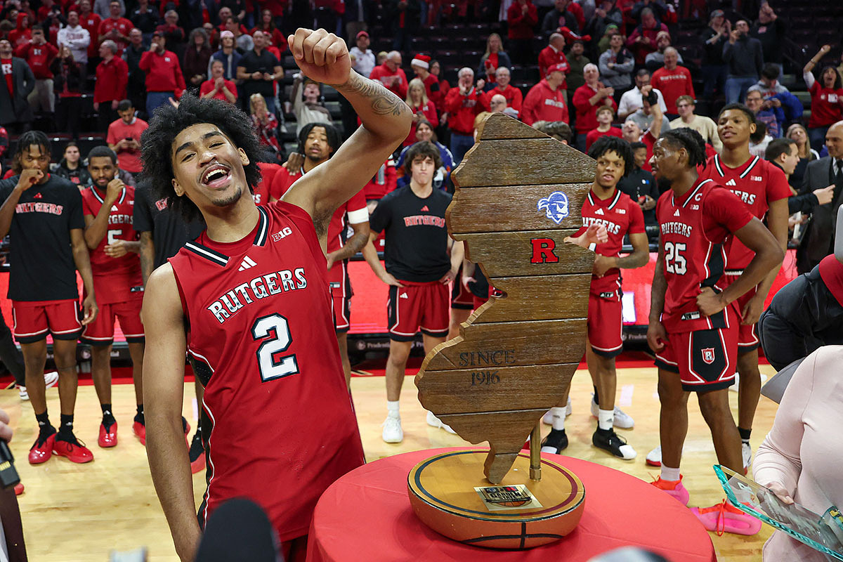 Rutgers Scarlet Knights guard Dylan Harper (2) celebrates with the Garden State Hardwood Classic trophy after defeating the Seton Hall Pirates at Jersey Mike's Arena.
