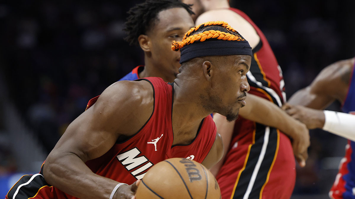 Miami Heat forward Jimmy Butler (22) is defended by Detroit Pistons forward Ronald Holland II (00) in the first half at Little Caesars Arena.