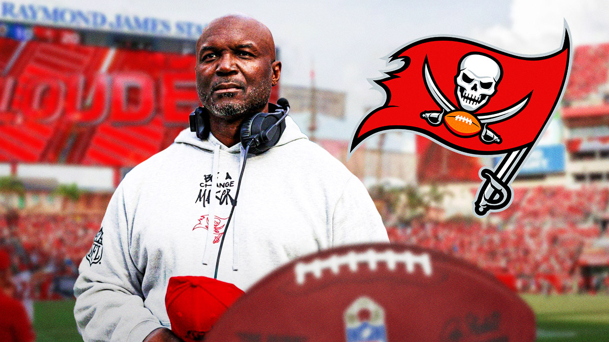 Todd Bowles looking serious next to a Buccaneers logo