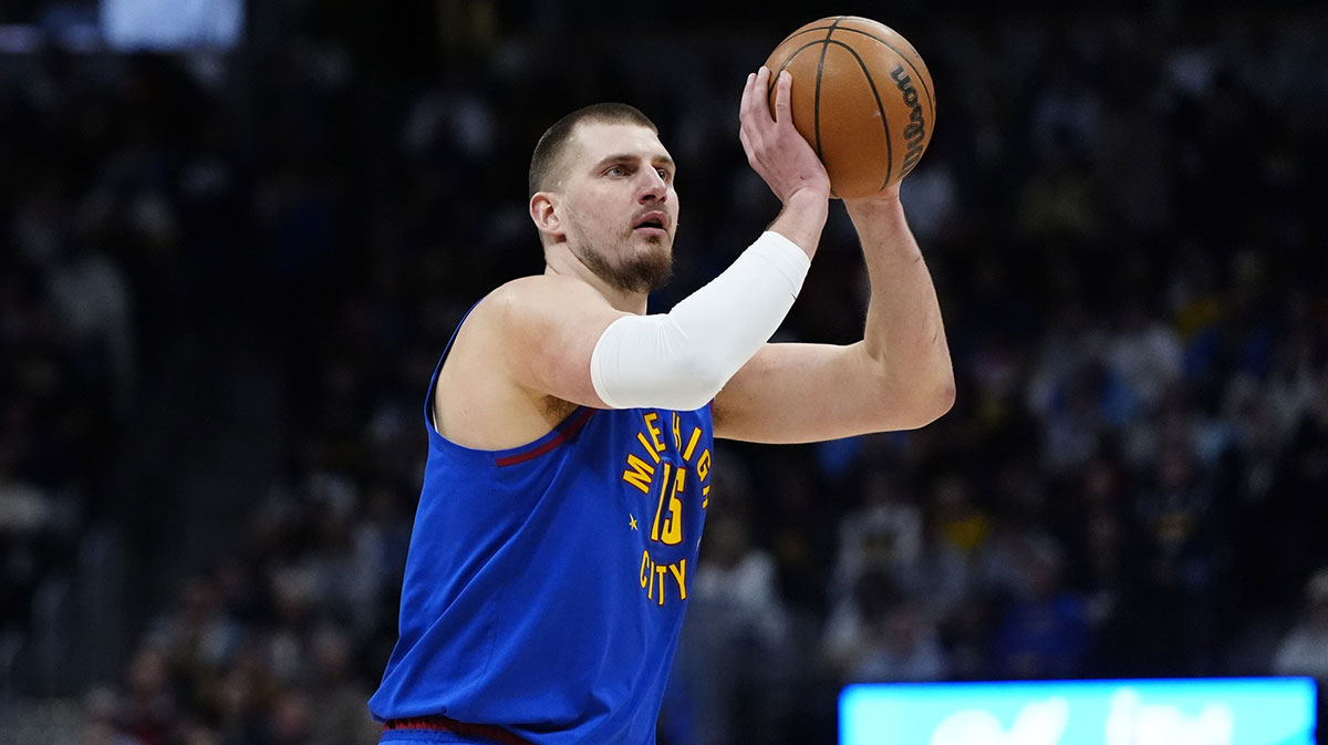 Denver Nuggets Center Nikola Jokic (15) lines up for a three-pointer in the first quarter against the Sacramento Kings at Ball Arena.