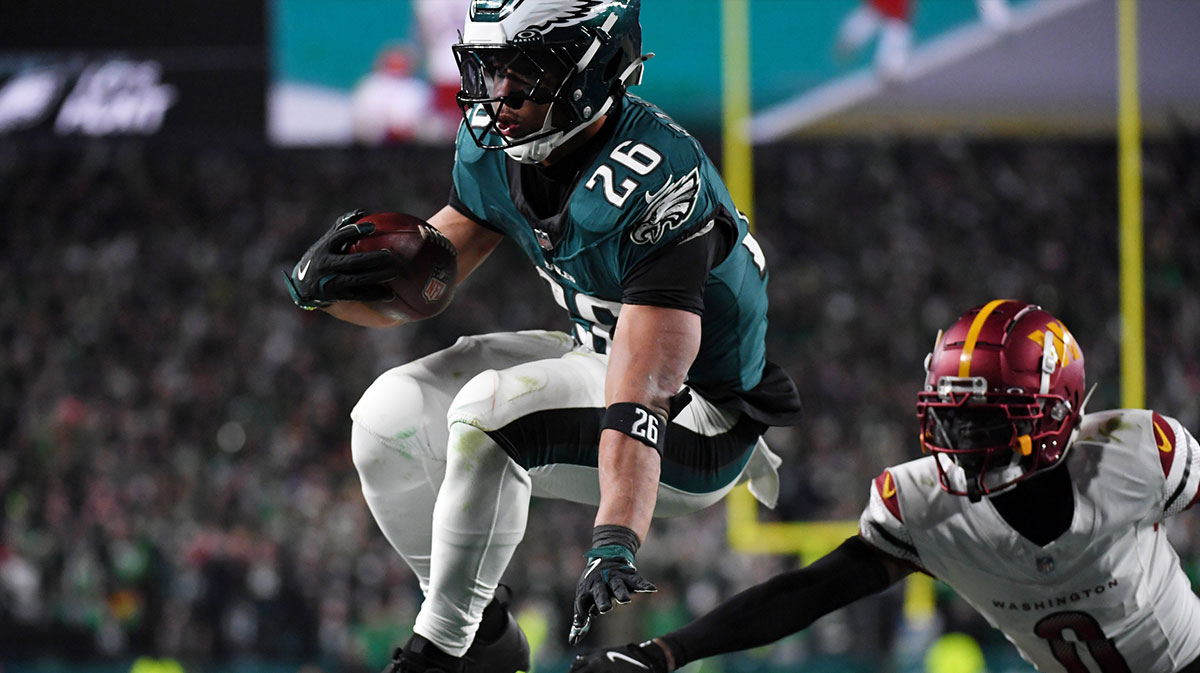 Philadelphia Eagles running back Saquon Barkley (26) leaps with the ball against the Washington Commanders during the second half in the NFC Championship game at Lincoln Financial Field.