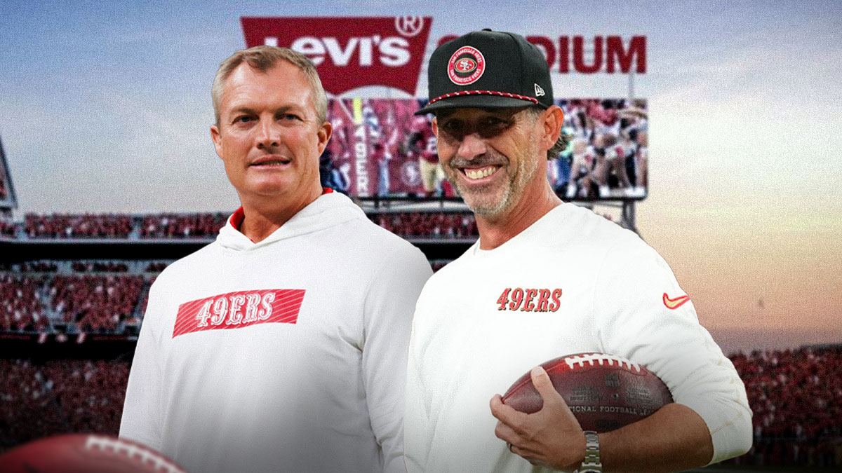 Kyle Shanahan next to John Lynch in front of the 49ers stadium