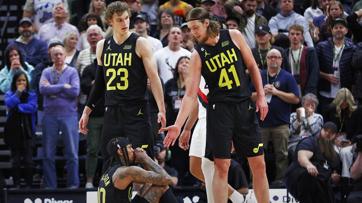 Utah Jazz guard Jordan Clarkson (00) shows his frustration refusing help from Utah Jazz forward Lauri Markkanen (23) and forward Kelly Olynyk (41) in the second half against the Portland Trail Blazers at Vivint Arena.