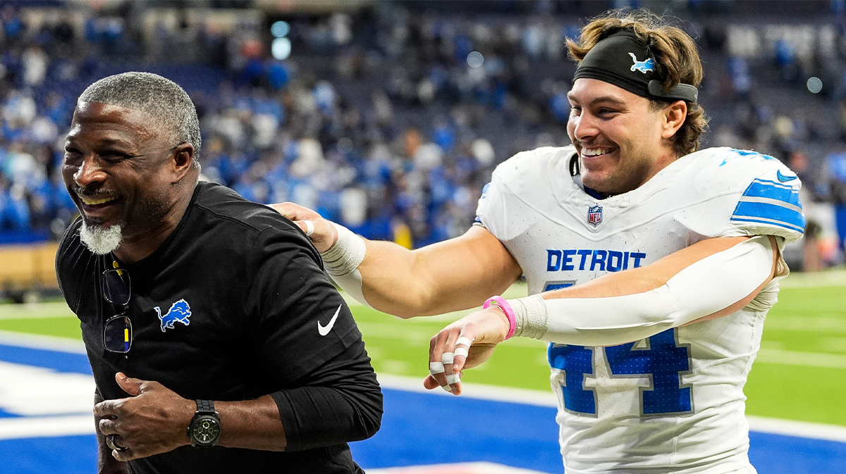 Detroit Lions defensive coordinator Aaron Glenn and linebacker Malcolm Rodriguez (44) celebrate 24-6 win over Indianapolis Colts as they exit the field at Lucas Oil Stadium in Indianapolis, Ind. on Sunday, Nov. 24, 2024.