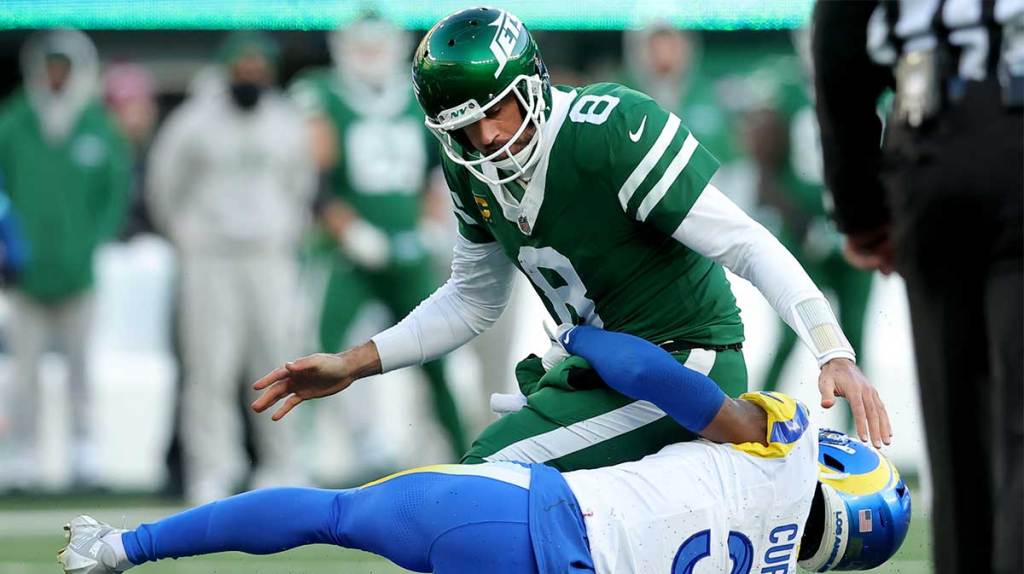 New York Jets quarterback Aaron Rodgers (8) fumbles the ball after a hit by Los Angeles Rams safety Kamren Curl (3) during the fourth quarter at MetLife Stadium.