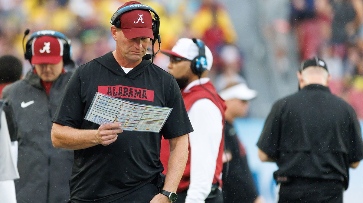 Alabama Crimson Tide head coach Kalen DeBoer reads the playcard against the Michigan Wolverines during the first half at Raymond James Stadium.