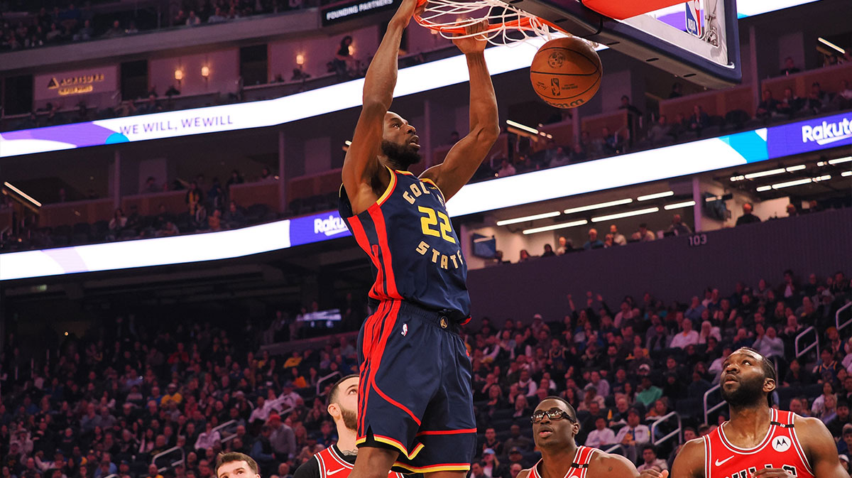 Golden State Warriors forward Andrew Wiggins (22) dunks the ball above three Chicago Bulls players during the first quarter at Chase Center.