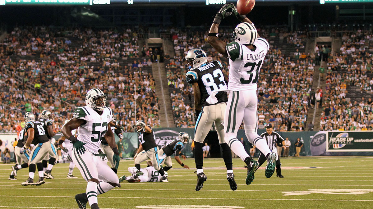 Carolina Panthers wide receiver Louis Murphy (83) misses the pass as New York Jets defensive back Antonio Cromartie (31) leaps for the ball during the first quarter at Met Life Stadium.