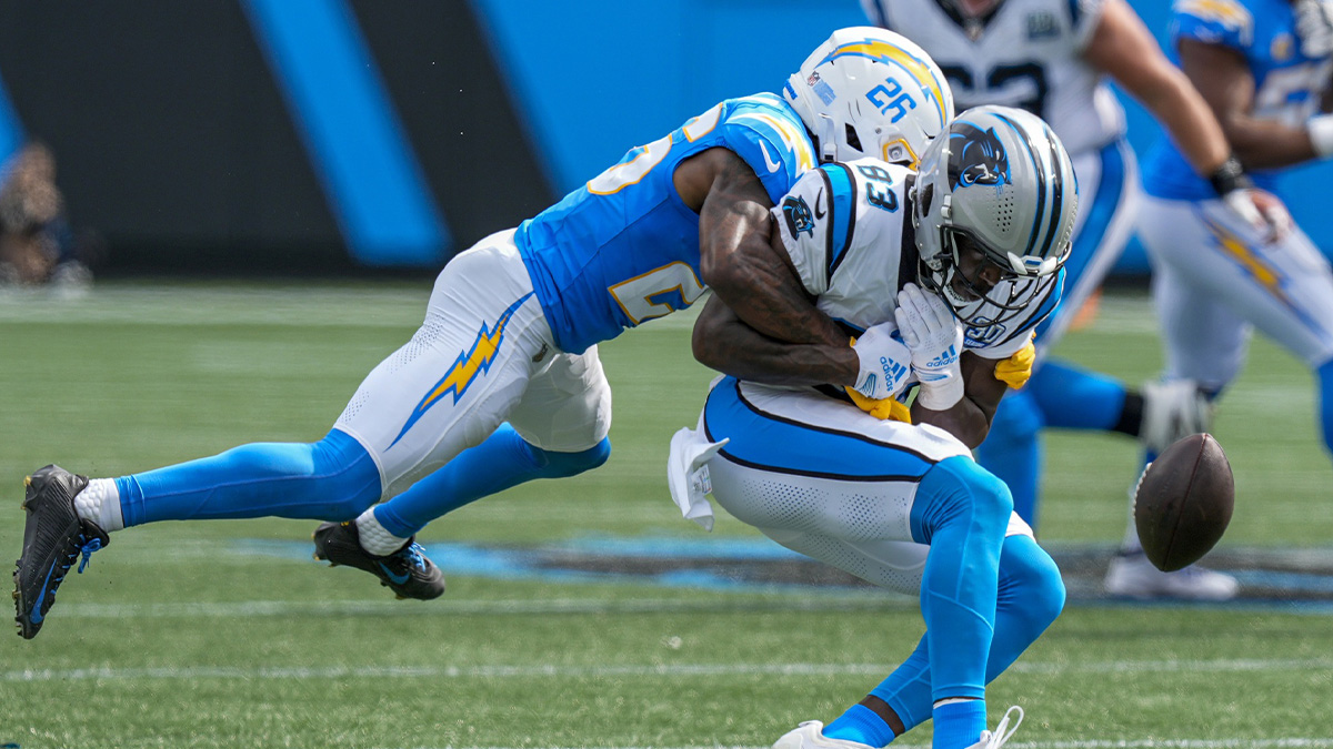 Los Angeles Chargers cornerback Asante Samuel Jr. (26) tackles Carolina Panthers defensive end LaBryan Ray (93) during the second half at Bank of America Stadium. 