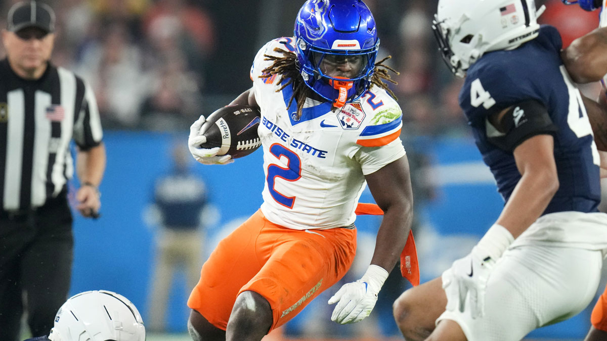 Boise State Broncos running back Ashton Jeanty (2) runs past Penn State Nittany Lions linebacker Kobe King (41) during their Vrbo Fiesta Bowl matchup at State Farm Stadium