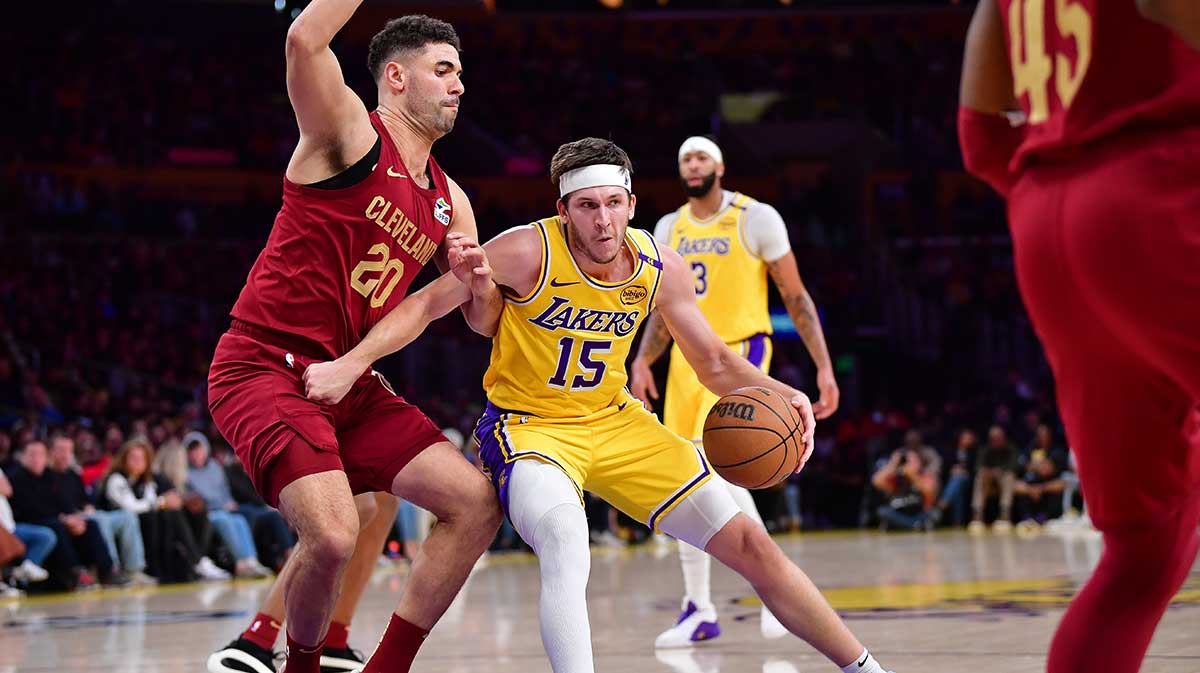 Los Angeles Lakers guard Austin Reaves (15) moves to the basket against Cleveland Cavaliers forward Georges Niang (20) during the first half at Crypto.com Arena.
